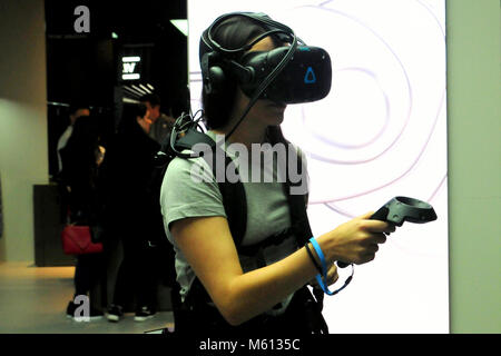 Barcelona, Spain. 27th Feb, 2018. A visitor seen trying out the virtual reality goggles at the Mobile World Congress.The Mobile World Congress 2018 is being hosted in Barcelona from 26 February to 1st March. Credit: Images from the second day of the 18th MWC in Barcelona  17 .jpg/SOPA Images/ZUMA Wire/Alamy Live News Stock Photo