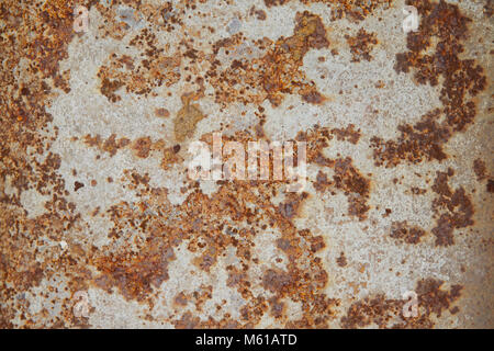 Dark worn rusty metal texture with white paint background Stock Photo