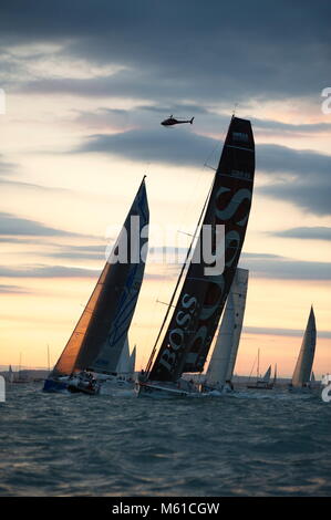 Alex Thomson's Open 60 racing yacht Hugo Boss (right) at the start of the 2013 Round the Island Race on the Solent, UK. Stock Photo