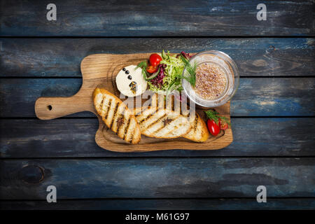 Toast with butter and caviar on a wooden background Stock Photo