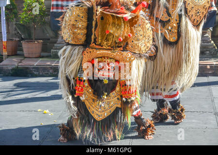 Balinese locals performing Barong, a mythical lion-like creature at a traditional ceremony in Bali. Stock Photo