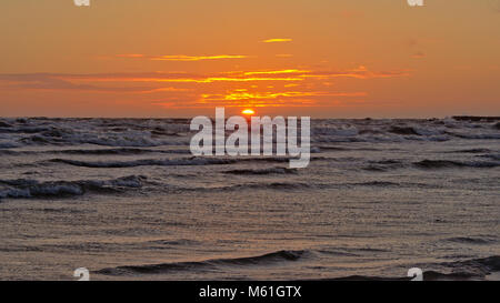 Warm orange sunset on on a summer evening over the baltic sea, seen from the beach of Liepaja, Latvia Stock Photo