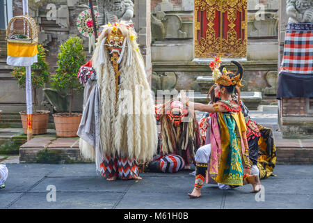 Balinese locals performing Barong, a mythical lion-like creature at a traditional ceremony in Bali. Stock Photo