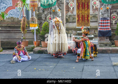 Balinese locals performing Barong, a mythical lion-like creature at a traditional ceremony in Bali. Stock Photo