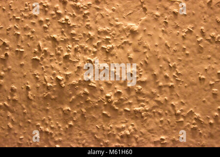 Coarse grained wall paint in dark cream color. Stock Photo