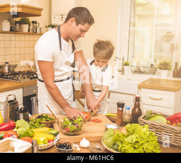 Father is cooking with his son Stock Photo