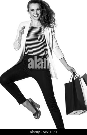 Luxury Shopping. The French way. cheerful stylish woman in white jacket isolated on white background with shopping bags painted in the color of the Fr Stock Photo