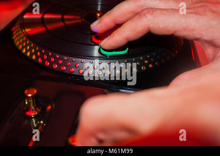 Male hands playing dj with toy turntable of console on a party Stock Photo