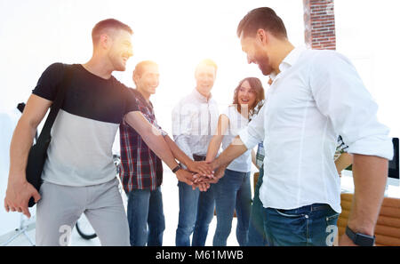 closeup .friendly team of designers clasped their hands together.the concept of teamwork Stock Photo