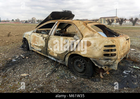 Stolen, abandoned, and burned out car. Stock Photo
