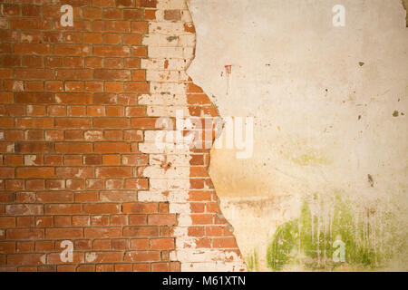 Old red brick wall with half lime plastered Stock Photo