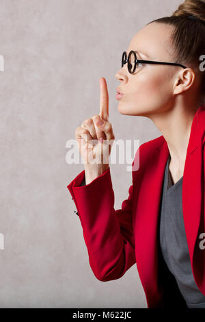Young caucasian lady between 30 and 40 years old dressed in a gray dress. Closeup Stock Photo
