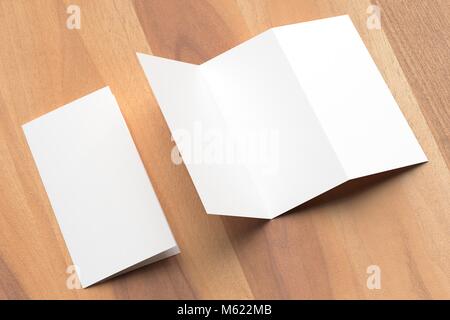 Thrifold - Three fold brochure mock up on wooden background. 3d illustrating Stock Photo