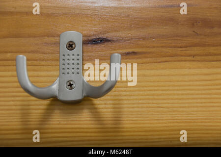 Metal hook hanger on a wooden counter in the sauna Stock Photo