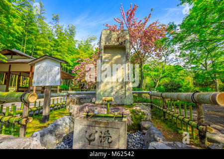 Kyoto, Japan - April 27, 2017: fountain in the Hyakka-en garden in the north side of Taho-den Hall inside Tenryu-ji, the most important Zen Temple in Arashiyama, Kyoto. Spring season in a sunny day. Stock Photo