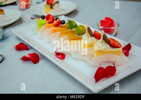 Cake cut into pieces on the table. Stock Photo