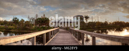 Sunset over Gazebo on a wooden secluded, tranquil boardwalk along a marsh pond in Freedom Park in Naples, Florida Stock Photo