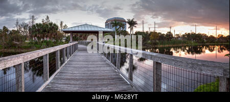 Sunset over Gazebo on a wooden secluded, tranquil boardwalk along a marsh pond in Freedom Park in Naples, Florida Stock Photo