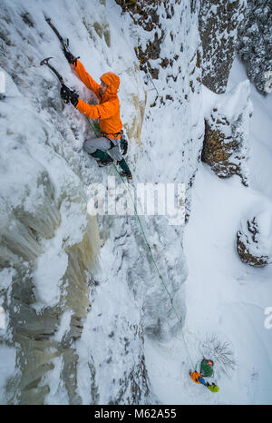 Jed Weber on a route called Switchback Falls rated WI3 in Hyalite Canyon near Bozeman Montana Stock Photo