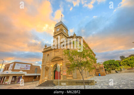 Albany, Australia - Dec 28, 2017: iconic Albany Town Hall with its four-faced clock tower opened in 1888 in Albany, Western Australia. Perspective view of old stone building in main street at sunset. Stock Photo