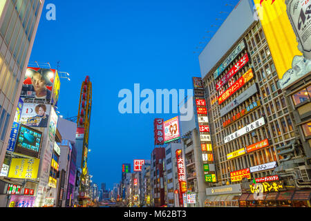 Osaka, Japan - April 29, 2017: modern buildings covered with neon signs along Dotonbori Canal in Namba, a popular shopping and entertainment district. Dotonbori Canal is a famous sightseeing spot Stock Photo