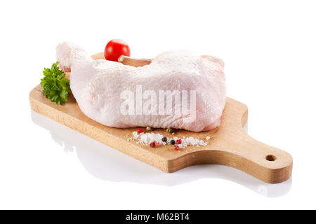 Raw chicken leg on cutting board on white background Stock Photo