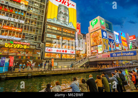 Osaka, Japan - April 29, 2017: people in Dotonbori Osaka, Namba District, in blue hour shot. The Dotonbori Canal is a famous sightseeing spot in Osaka and is a place visited by many tourists. Stock Photo