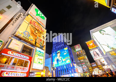 Osaka, Japan - April 29, 2017: bright neon signboard and crowd of people at entrance of Ebisu Bashi-Suji Shopping Street in Namba District, one of the main tourist destinations in Osaka, japan. Stock Photo