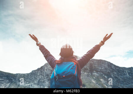 Image of woman with backpack against background of mountain landscape Stock Photo