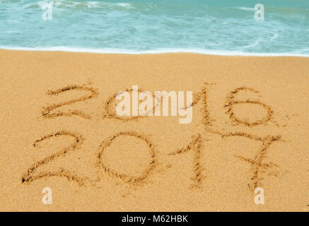digits  2016 and 2017 on the beach - concept of new year and passing of time Stock Photo