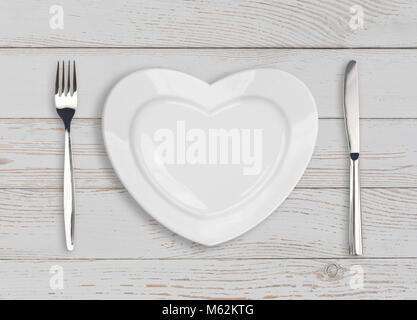 empty heart plate top view on white wood table Stock Photo