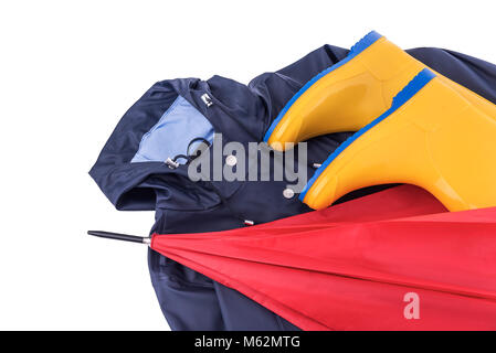 Raincoat and umbrella and rubber boots on a white background. Stock Photo
