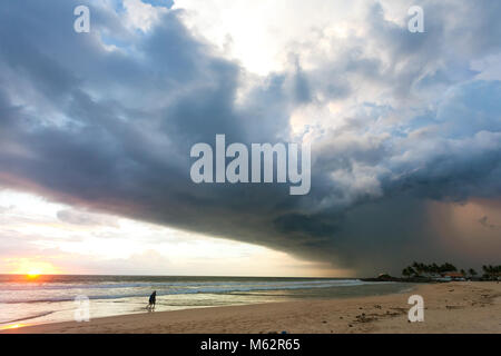 Ahungalla Beach, Sri Lanka, Asia - Impressive atmosphere disturbance during sunset at the beach of Ahungalla Stock Photo