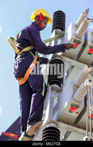 Electricians working on high voltage power lines. Highly skilled workmen servicing the electricity grid Stock Photo