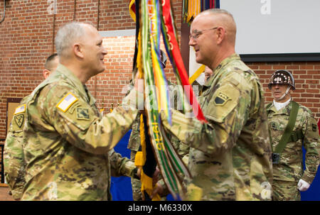 (Left) Maj. Gen. Bruce Hackett, commander of the 80th Training Command, receives the unit's guidon from Command Sgt. Maj. Jeffrey Darlington at the command's change of responsibility ceremony held at the Defense Supply Center Richmond, Virginia, during the 80th TC Commander's Readiness Workshop Feb. 8, 2018.  As the outgoing senior enlisted leader of the 80th TC, Darlington handed over the reins to the incoming senior enlisted leader Command Sgt. Maj. Dennis Thomas. Stock Photo