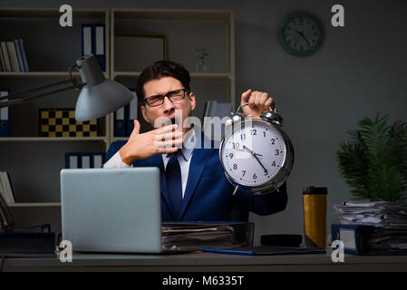 Businessman falling asleep during long hours in office Stock Photo
