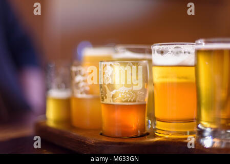 low angle closeup of beer flight at microbrewery in Chicago in sunlight Stock Photo