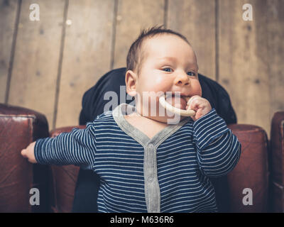 A little baby is chewing on a teething ring Stock Photo