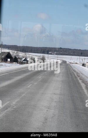 smooth aspalt road toward the forest beautiful trip in cold winter day Stock Photo
