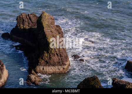 Sea stack with crashing waves Stock Photo