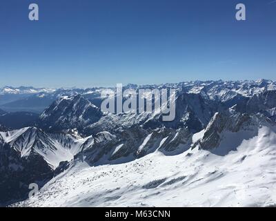zugspitze, germany in summer. Aerial of mountain view with snow and blue sky in summer. Stock Photo