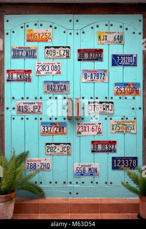 USA license plate. House door adorned and decorated with various American car number plates. Stock Photo