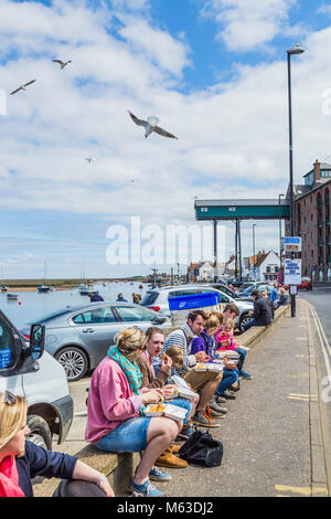 Enjoying fish and chips on the quayside at Wells next the Sea. Stock Photo