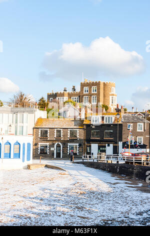 England, Broadstairs. Bleak House, of Charles Dickens fame, on cliff top over looking the town and snow covered beach at Viking Bay. Bright sunshine, blue sky with white clouds. Wintertime. Stock Photo