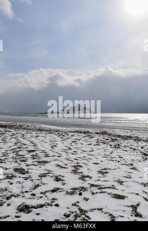 Marazion, Corwall, UK, 28th Feb 2018. UK Weather. Snow on the beach on St Michaels Mount and the beach at Marazion, as the beast from the east hits Cornwall. Credit: Simon Maycock/Alamy Live News Stock Photo