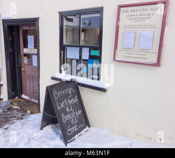 Norwich, Norfolk, UK. 28th February, 2018. The Britons Arms café, on historic Elm Hill in Norwich, stays open despite snowy weather, with a sign outside, 'We Beat the Beast from the East' 28 February 2018 Credit: SPK/Alamy Live News Stock Photo