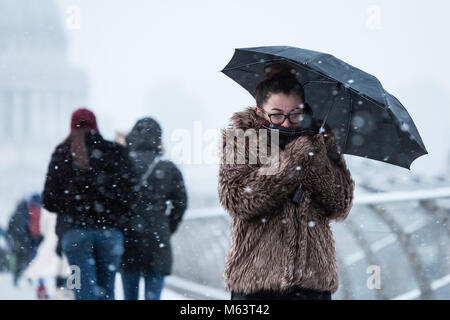 London, UK. 28th Feb, 2018. UK Weather: Tourists and commuters cross the Millennium Bridge during a blizzard. The continued freeze dubbed ‘The Beast From The East’ has brought extreme arctic conditions to the capital and across the UK. Credit: Guy Corbishley/Alamy Live News Stock Photo