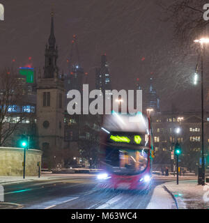 London, England, UK. 28th Feb, 2018. UK Weather: A double-decker bus battles through the 'Beast From The East' snowstorm amongst the buildings of the City of London. Credit: Joe Dunckley/Alamy Live News Stock Photo