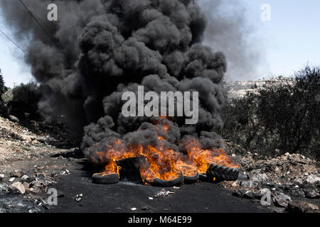 Israeli-Palestinian conflict: tires on fire during protest demonstration against illegal israeli settlement. Kafr Qaddum - Palestine Stock Photo