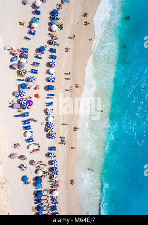 Tourists relaxing on the Egremni Beach in Lefkada swimming and playing games in the water Stock Photo